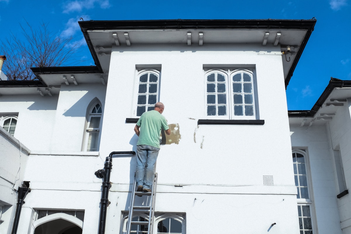 Painter on scaffold working on building exterior